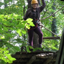 Marion in the trees of a high rope course